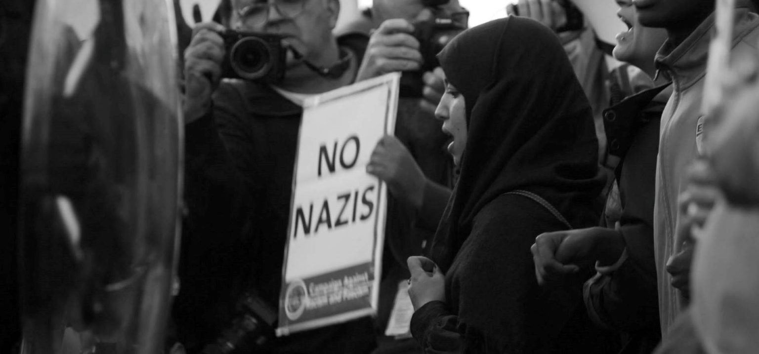 woman in black hijab at an antifascist rally