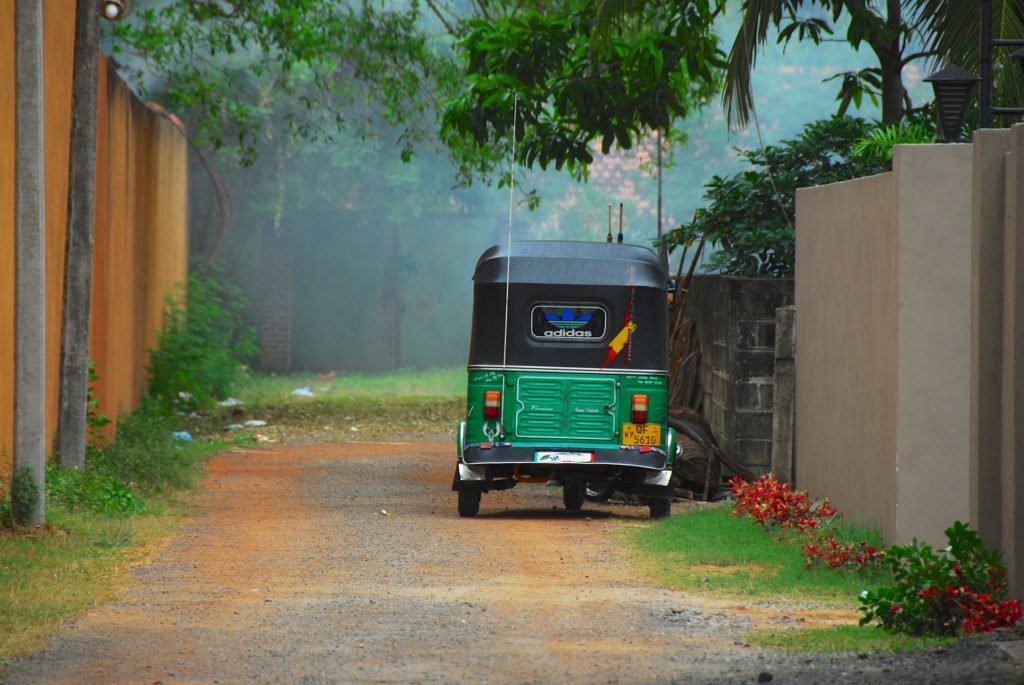 a motorised rickshaw with the adidas logo on the back