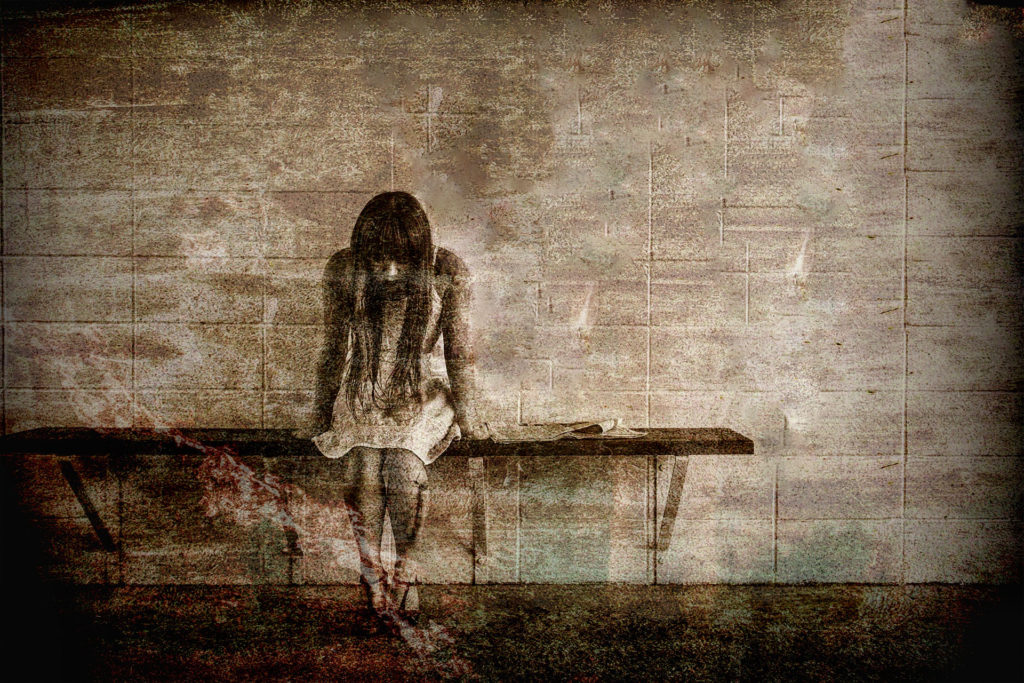 a sad figure on a bench