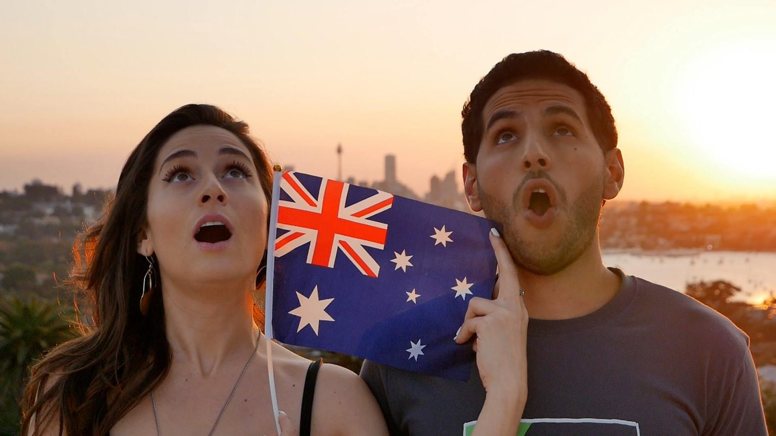 image of woman and man holding an Australian flag