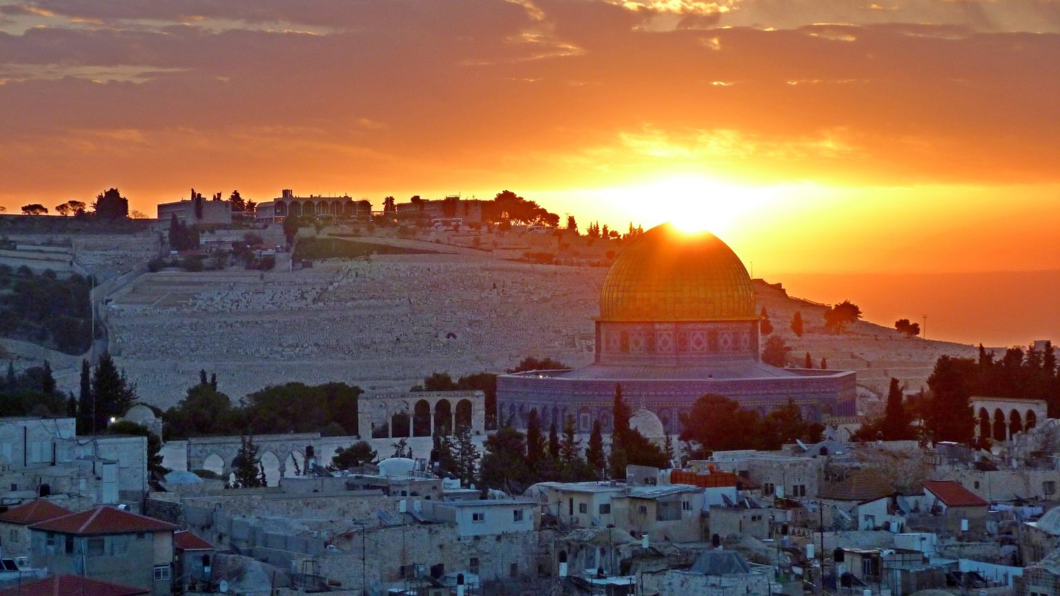 Beyond Western categorisations: Arab and Jewish sun setting over a city with a domed building