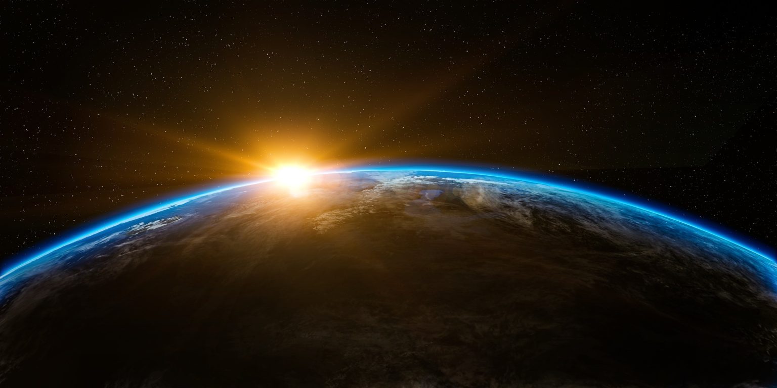 photo from space showing the sun rising over the planet
