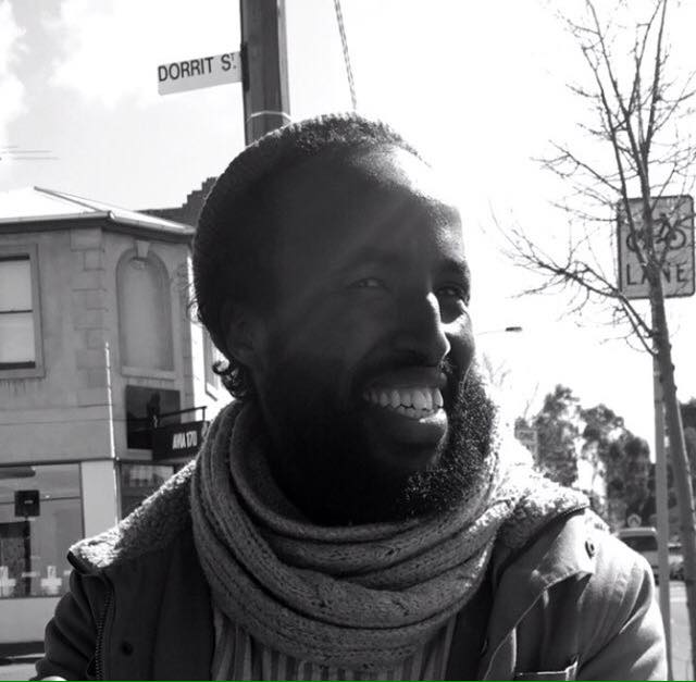 Magan Magan in the sunlight on Dorrit St wearing a scarf and beanie