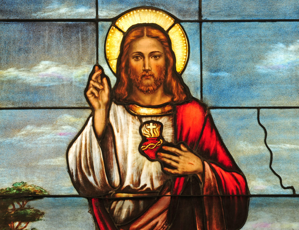 a stained-glass window showing Jesus Christ giving a blessing