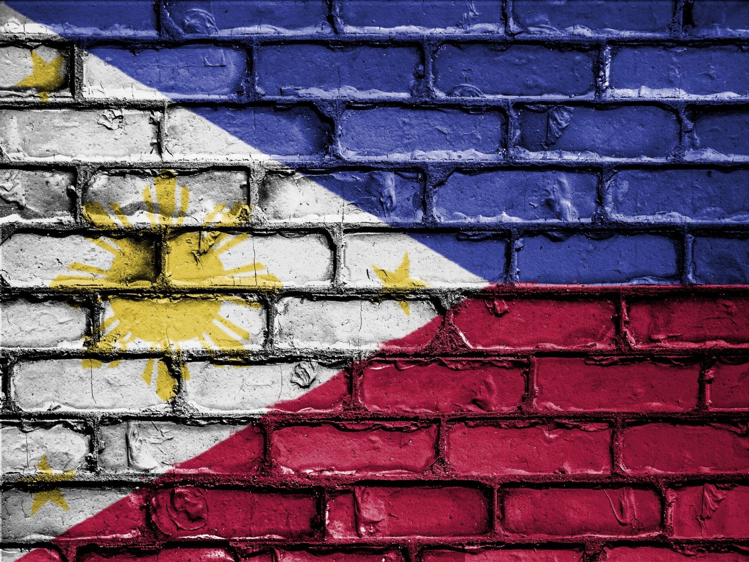 Philippine national flag painted on a brick wall