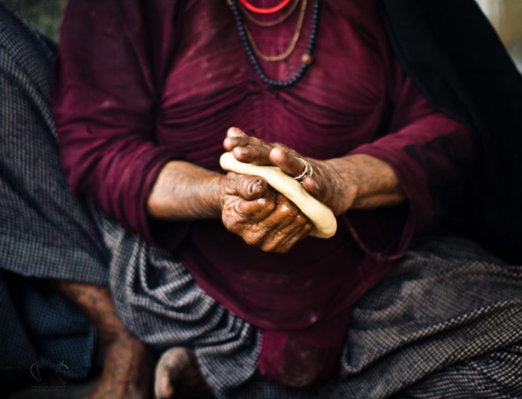 close up shot of an elderly person making bread